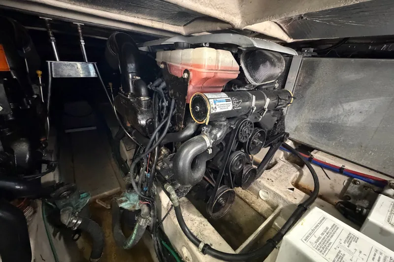 Slide: The Image of Engine compartment of a 2010 Sea Ray 390 Sedan Bridge, showcasing mechanical components. - 135