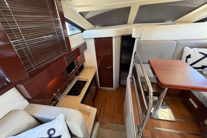 Slide: The Image of Interior of 2010 Sea Ray 390 Sedan Bridge yacht with modern kitchen and dining area. - 62