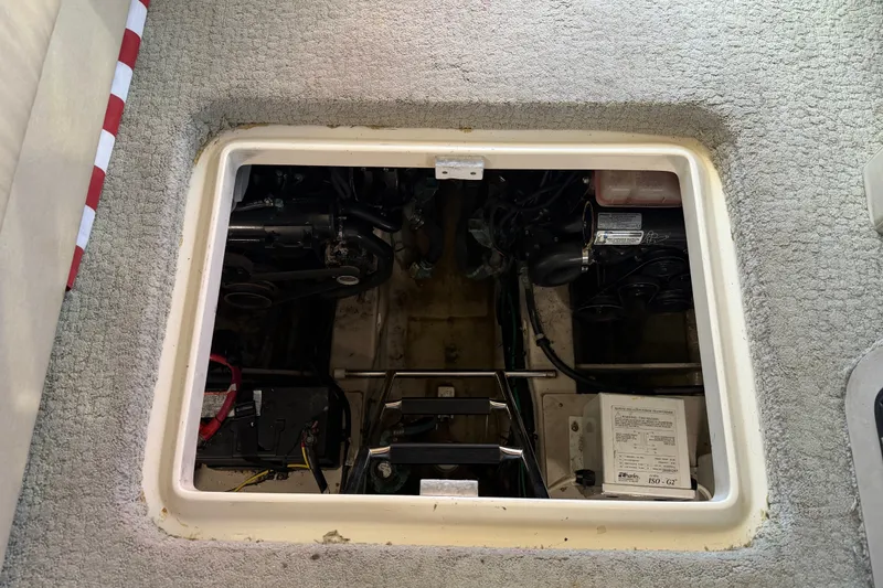 Slide: The Image of Engine compartment of a 2010 Sea Ray 390 Sedan Bridge boat, showcasing mechanical components. - 132