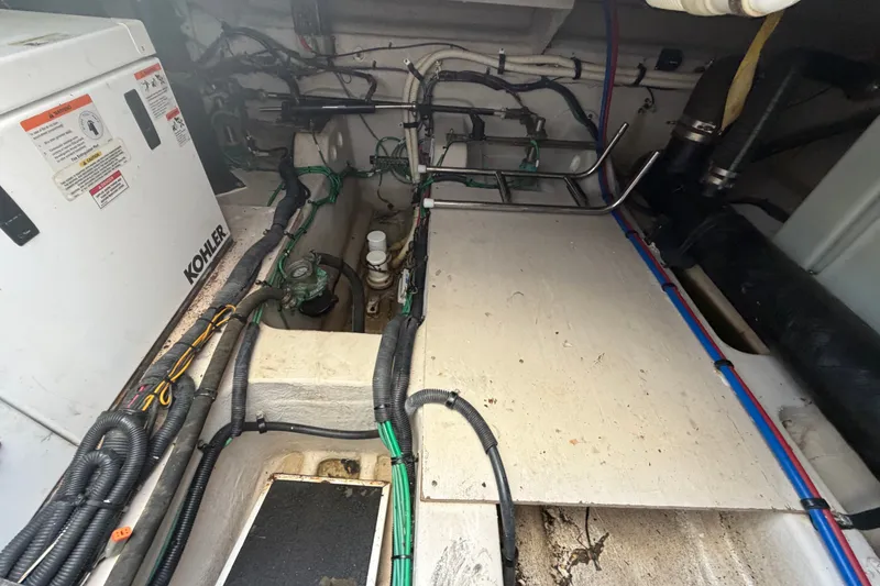 Slide: The Image of Engine room of a 2010 Sea Ray 390 Sedan Bridge with Kohler generator and wiring. - 145