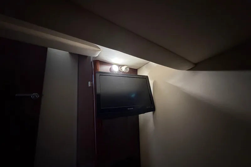 Slide: The Image of Interior of 2010 Sea Ray 390 Sedan Bridge with mounted TV and overhead lighting. - 130