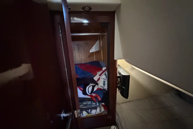 Slide: The Image of Interior cabin closet of 2010 Sea Ray 390 Sedan Bridge with folded clothes. - 127