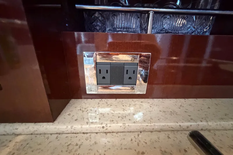 Slide: The Image of Power outlet on Sea Ray 390 Sedan Bridge 2010, set in polished wood panel. - 75