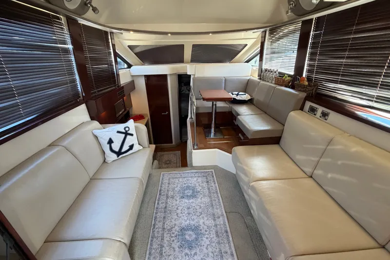 Slide: The Image of Luxurious interior of 2010 Sea Ray 390 Sedan Bridge with beige seating and nautical decor. - 50