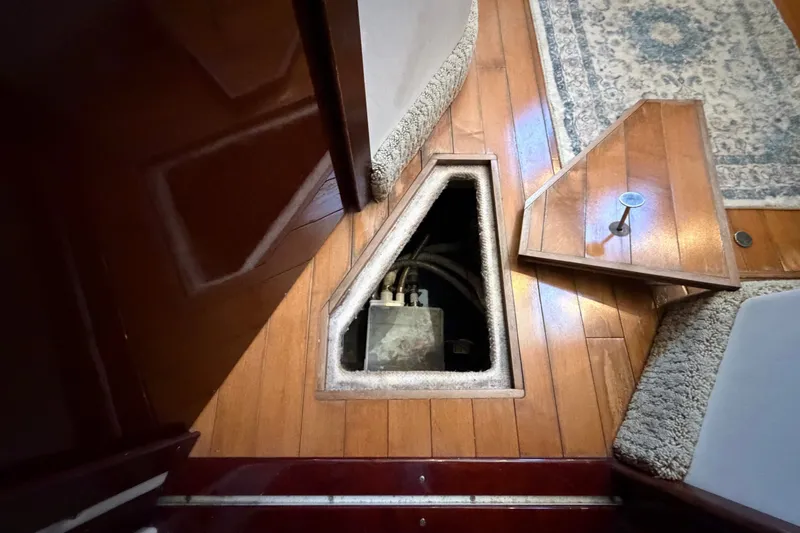Slide: The Image of Interior view of 2010 Sea Ray 390 Sedan Bridge with wooden flooring and hatch. - 97