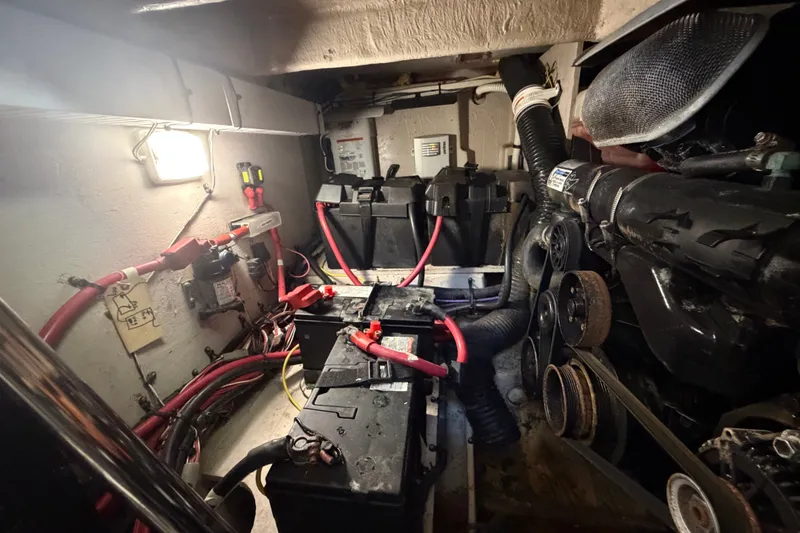Slide: The Image of Engine room of 2010 Sea Ray 390 Sedan Bridge with batteries and wiring. - 143