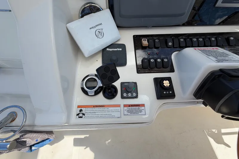 Slide: The Image of Control panel of a 2010 Sea Ray 390 Sedan Bridge with various instruments and switches. - 41