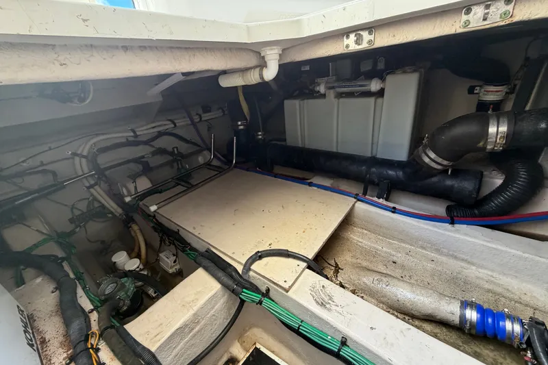 Slide: The Image of Engine compartment of a 2010 Sea Ray 390 Sedan Bridge, showing pipes and wiring. - 146