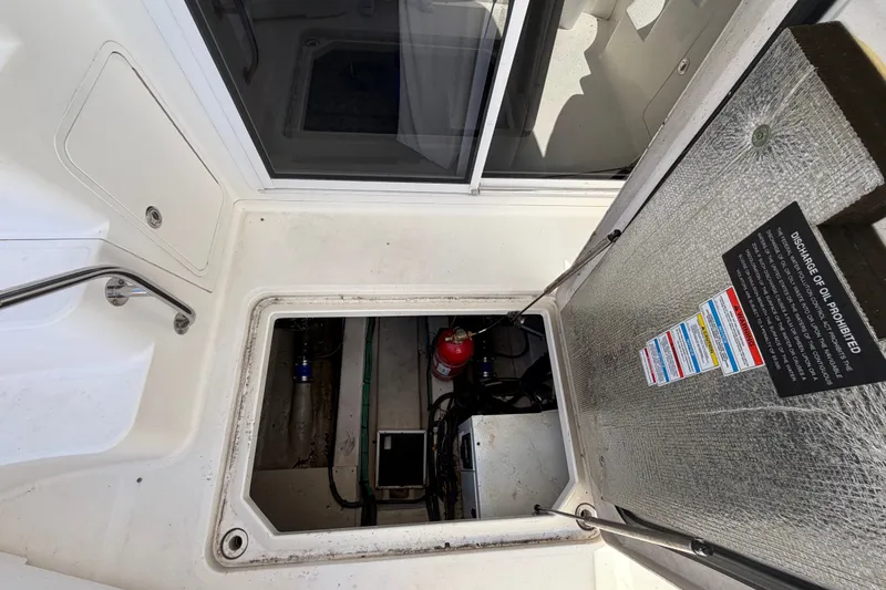 Slide: The Image of Engine compartment of 2010 Sea Ray 390 Sedan Bridge with safety equipment visible. - 148