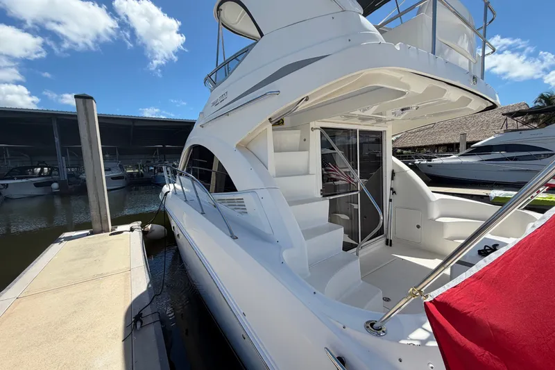 Slide: The Image of 2010 Sea Ray 390 Sedan Bridge yacht docked under a clear blue sky. - 17