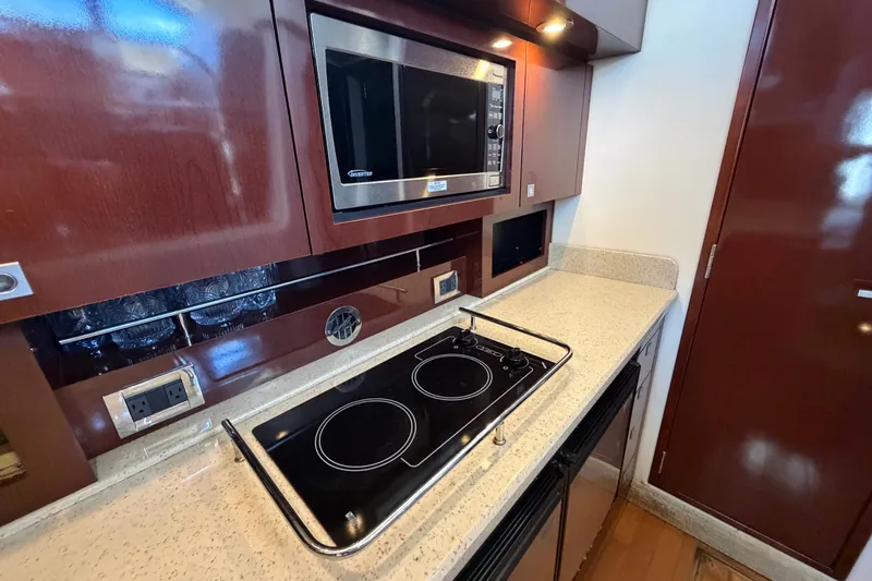Slide: The Image of Modern kitchen in 2010 Sea Ray 390 Sedan Bridge yacht with stove and microwave. - 58
