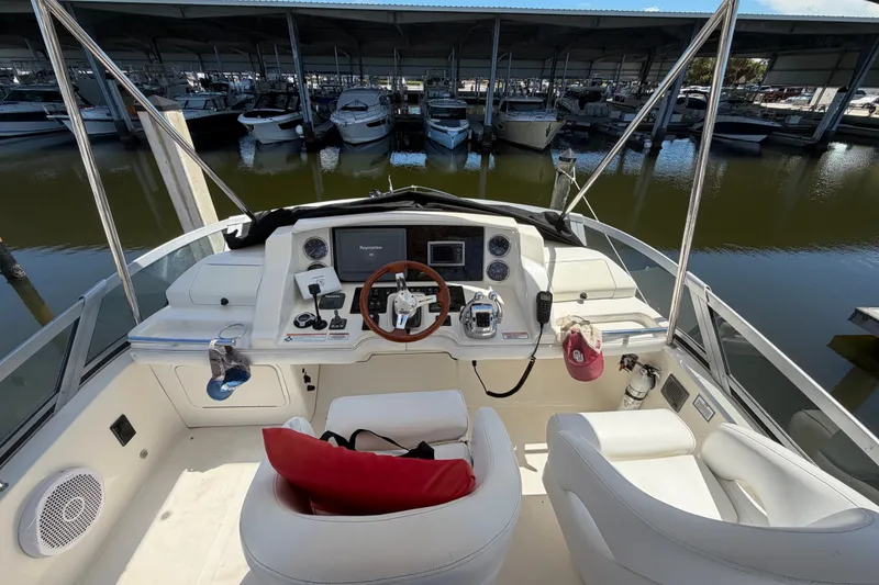 Slide: The Image of Cockpit view of 2010 Sea Ray 390 Sedan Bridge yacht in marina. - 37