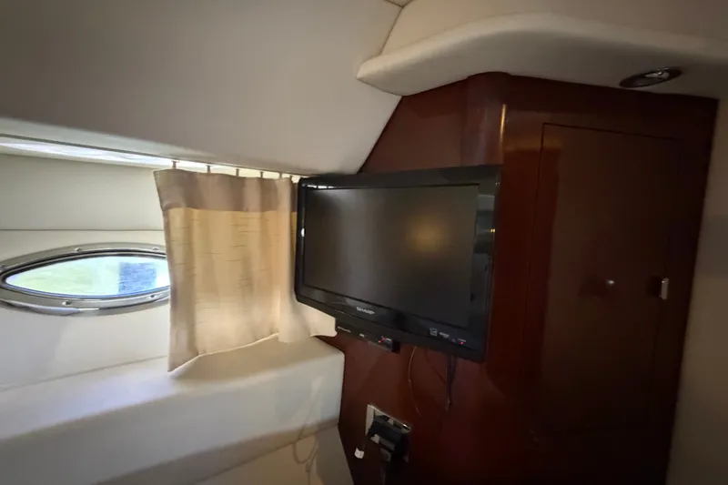 Slide: The Image of Interior of 2010 Sea Ray 390 Sedan Bridge with TV and porthole window. - 106