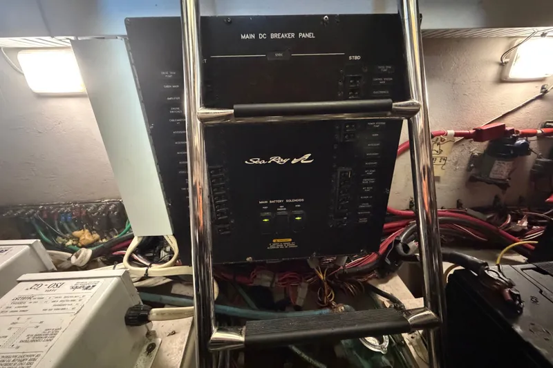 Slide: The Image of Main DC breaker panel on 2010 Sea Ray 390 Sedan Bridge yacht, with wiring and equipment. - 142
