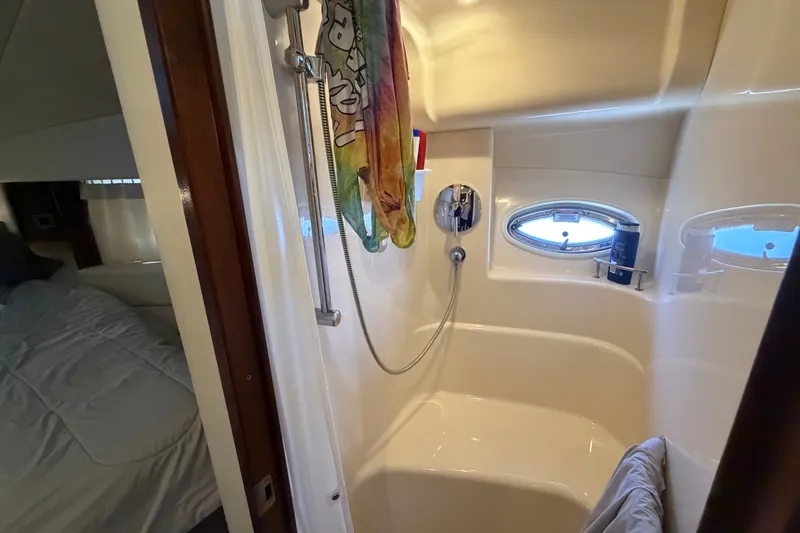 Slide: The Image of Bathroom interior of 2010 Sea Ray 390 Sedan Bridge yacht with shower and porthole window. - 115