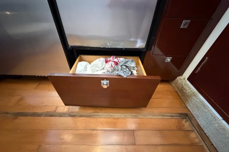 Slide: The Image of Open drawer with plastic bags in a 2010 Sea Ray 390 Sedan Bridge kitchen. - 65