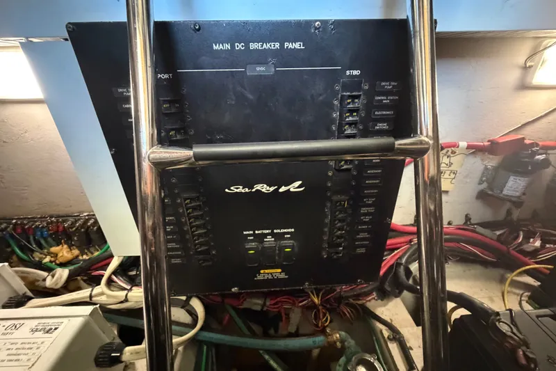 Slide: The Image of Main DC breaker panel on 2010 Sea Ray 390 Sedan Bridge yacht, featuring electrical controls and wiring. - 140
