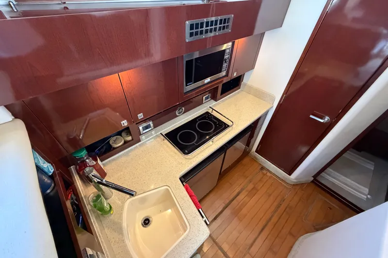 Slide: The Image of Modern kitchen in 2010 Sea Ray 390 Sedan Bridge yacht with wood cabinetry and appliances. - 59