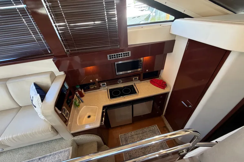 Slide: The Image of Luxurious kitchen interior of 2010 Sea Ray 390 Sedan Bridge yacht with modern amenities. - 91