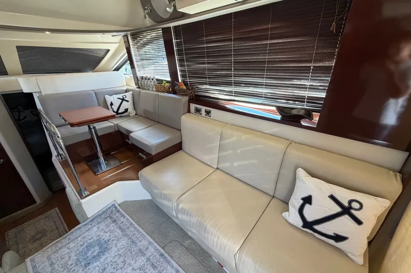 Slide: The Image of Luxurious interior of 2010 Sea Ray 390 Sedan Bridge with beige seating and nautical decor. - 52