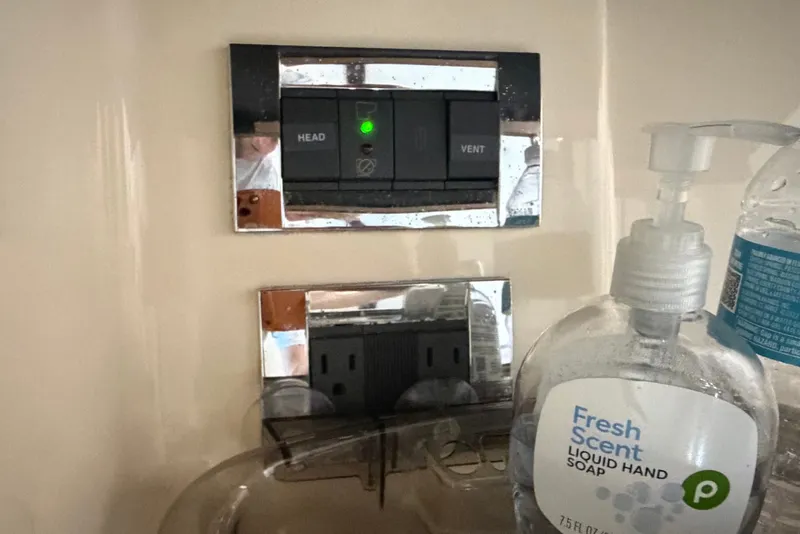 Slide: The Image of Hand soap and water bottle on Sea Ray 390 Sedan Bridge, 2010 model, near control panel. - 120
