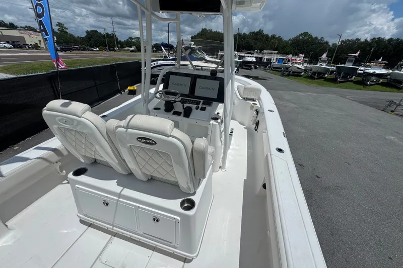 Slide: The Image of 2019 Blue Wave 2800 Pure Hybrid boat interior with dual seats and Garmin displays. - 17