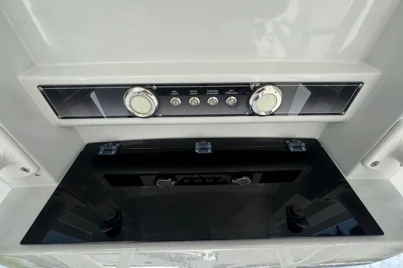 Slide: The Image of Control panel of a 2019 Blue Wave 2800 Pure Hybrid boat with switches and gauges. - 24