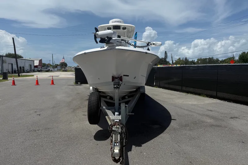 Slide: The Image of 2019 Blue Wave 2800 Pure Hybrid boat on trailer, parked outdoors under a cloudy sky. - 62