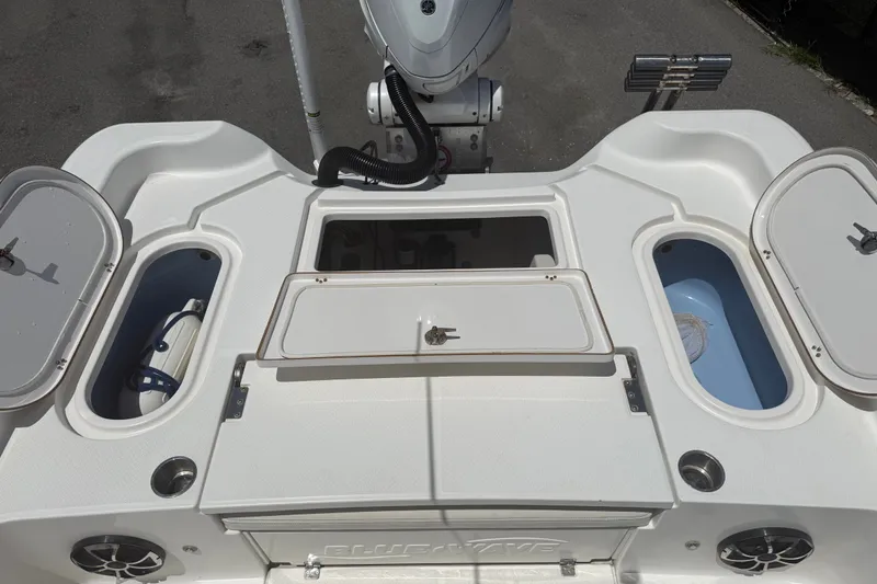 Slide: The Image of 2019 Blue Wave 2800 Pure Hybrid boat deck with storage compartments and motor. - 59