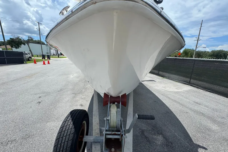 Slide: The Image of 2019 Blue Wave 2800 Pure Hybrid boat on trailer, under a partly cloudy sky. - 14