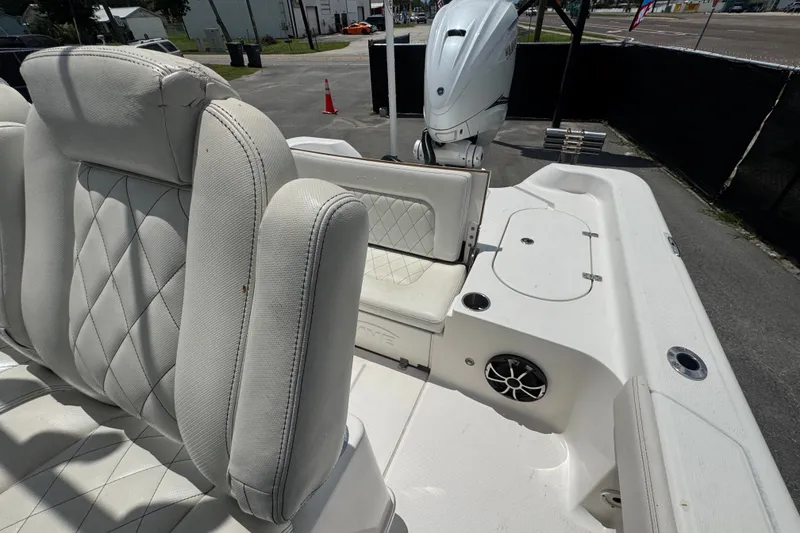 Slide: The Image of 2019 Blue Wave 2800 Pure Hybrid boat interior with white cushioned seating and motor. - 55