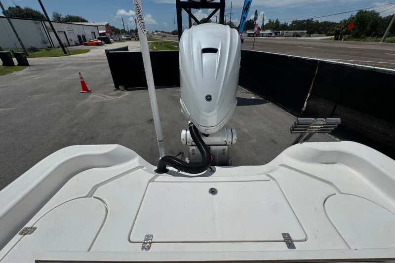 Slide: The Image of 2019 Blue Wave 2800 Pure Hybrid boat with outboard motor, parked on a sunny day. - 58