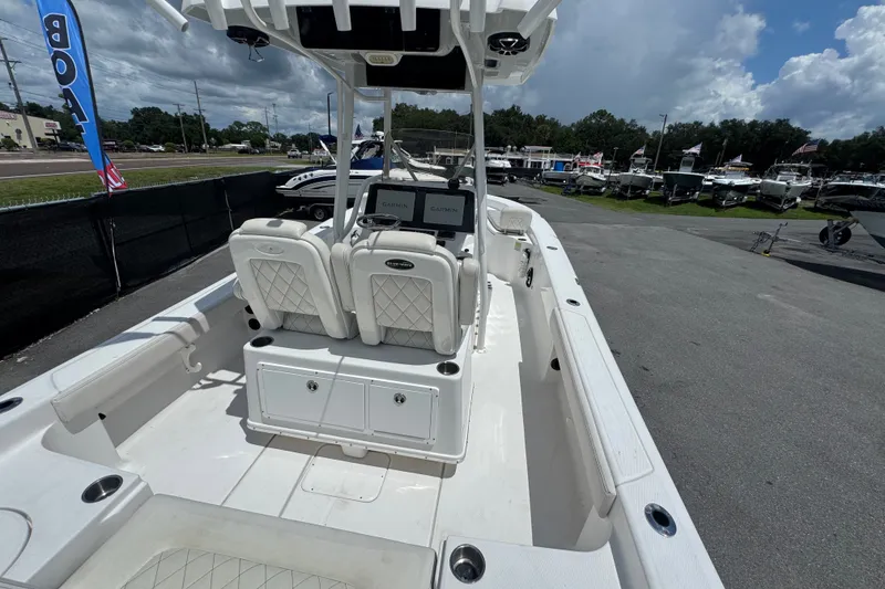 Slide: The Image of 2019 Blue Wave 2800 Pure Hybrid boat interior with dual seats and Garmin displays. - 16