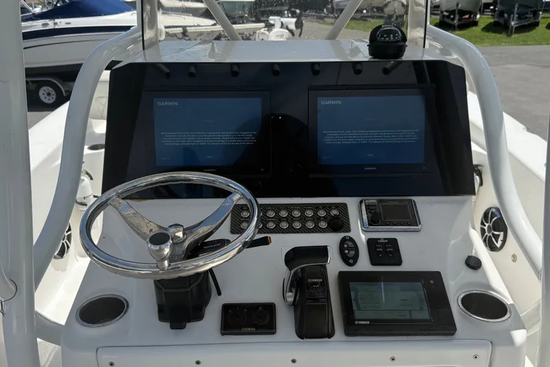 Slide: The Image of Control panel of 2019 Blue Wave 2800 Pure Hybrid boat with Garmin displays and steering wheel. - 19