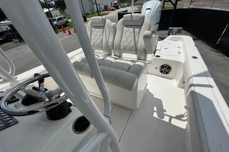 Slide: The Image of 2019 Blue Wave 2800 Pure Hybrid boat interior with plush seating and steering wheel. - 52