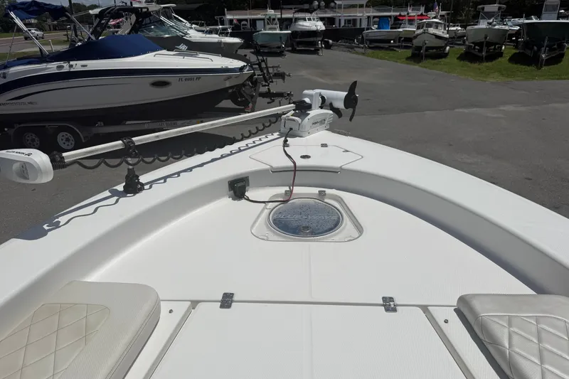 Slide: The Image of 2019 Blue Wave 2800 Pure Hybrid boat deck with trolling motor in marina setting. - 29