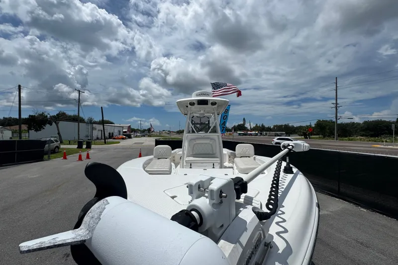 Slide: The Image of 2019 Blue Wave 2800 Pure Hybrid boat with American flag, parked under cloudy sky. - 36