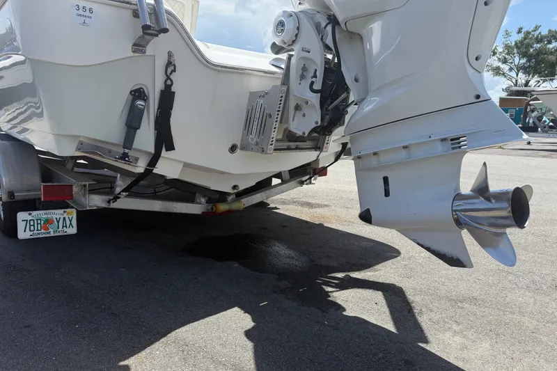 Slide: The Image of 2019 Blue Wave 2800 Pure Hybrid boat on trailer, showing outboard motor and propeller. - 10