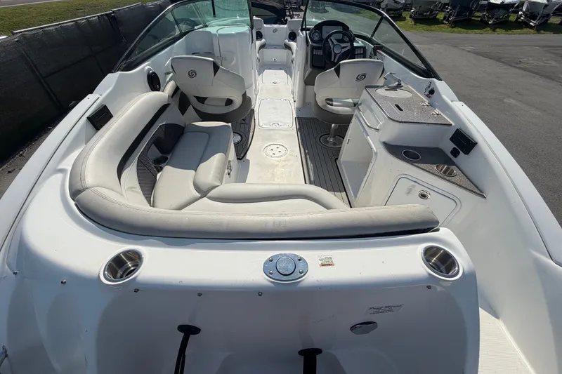 Slide: The Image of 2019 Hurricane SunDeck 2400 OB boat interior with seating and helm, showcasing spacious design. - 11