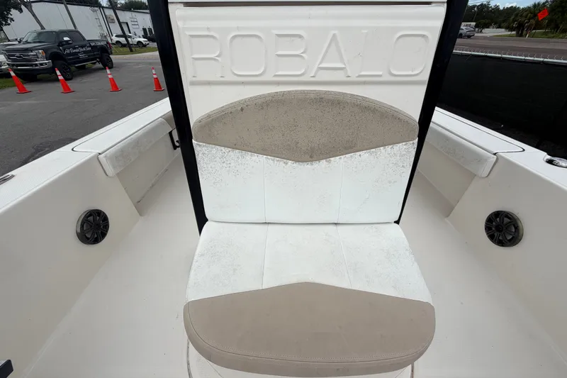Slide: The Image of 2019 Robalo 226 Cayman boat seat with visible wear and embossed branding. - 54