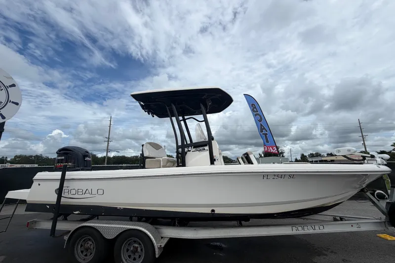 Slide: The Image of 2019 Robalo 226 Cayman boat on trailer under cloudy sky, for sale. - 1