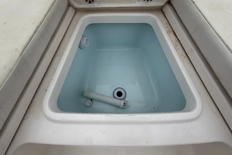 Slide: The Image of An open storage compartment on a 2019 Robalo 226 Cayman boat. - 40
