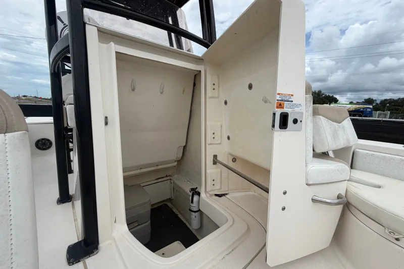 Slide: The Image of 2019 Robalo 226 Cayman boat interior storage compartment with open hatch. - 55