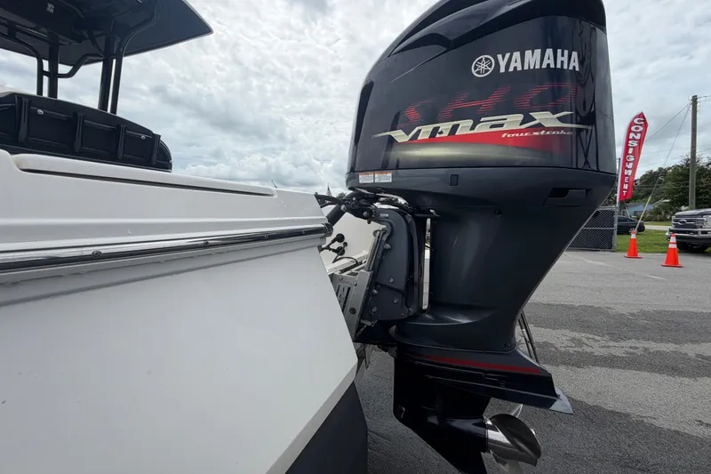 Slide: The Image of 2019 Robalo 226 Cayman with Yamaha VMAX outboard motor, parked outdoors. - 6