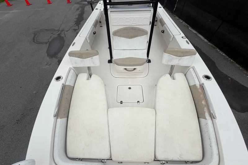 Slide: The Image of 2019 Robalo 226 Cayman boat interior with white seating and storage compartments. - 51