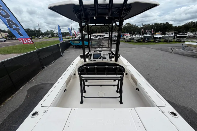 Slide: The Image of 2019 Robalo 226 Cayman boat on display at a dealership with sale banners. - 12