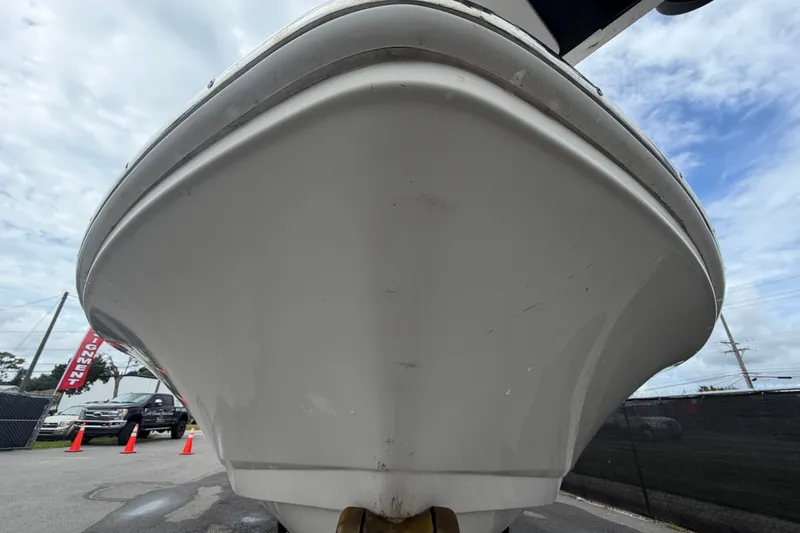 Slide: The Image of 2019 Robalo 226 Cayman boat hull, viewed from below, with cloudy sky background. - 10