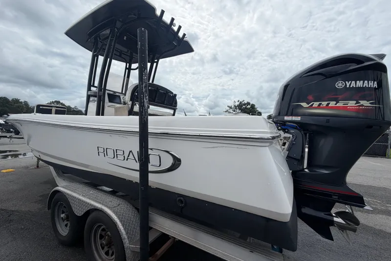 Slide: The Image of 2019 Robalo 226 Cayman boat with Yamaha VMAX engine on trailer, under cloudy sky. - 7