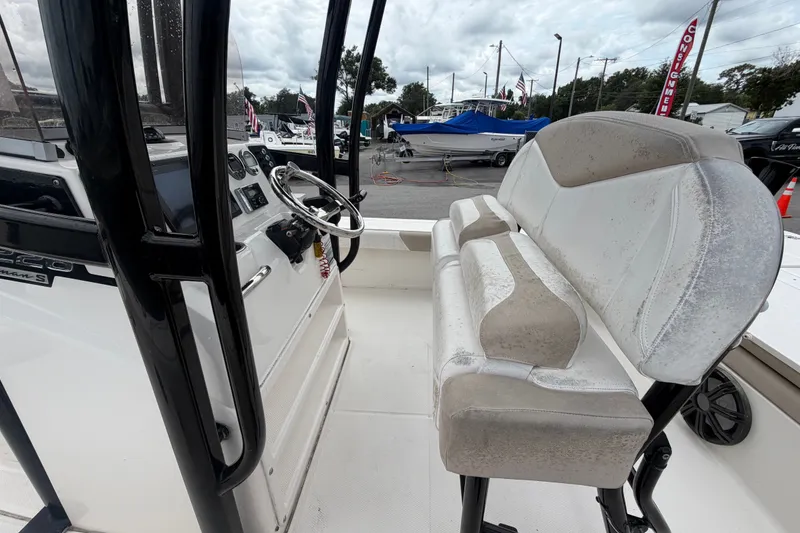 Slide: The Image of 2019 Robalo 226 Cayman boat interior with steering wheel and seating. - 19