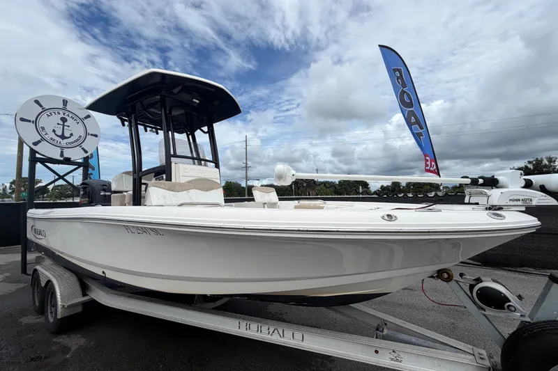 The Image of 2019 Robalo 226 Cayman boat on trailer under cloudy sky. - 0